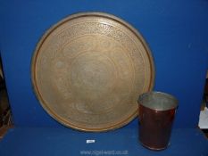 A small copper waste bin and a brass charger/Benares table top with Moorish style decoration,