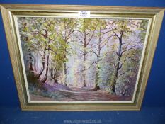 A framed Oil on board of a woodland scene with wild flowers and a track leading to a wooden gate,