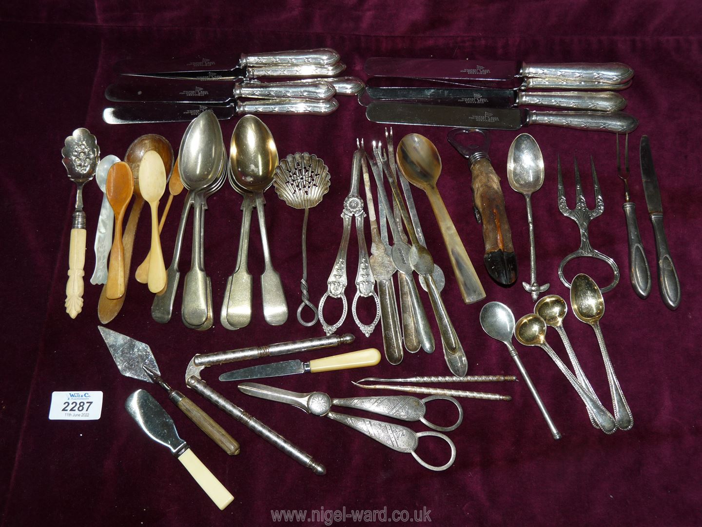 A quantity of cutlery including berry & sifter spoons, lobster picks, bottle opener, grape scissors,