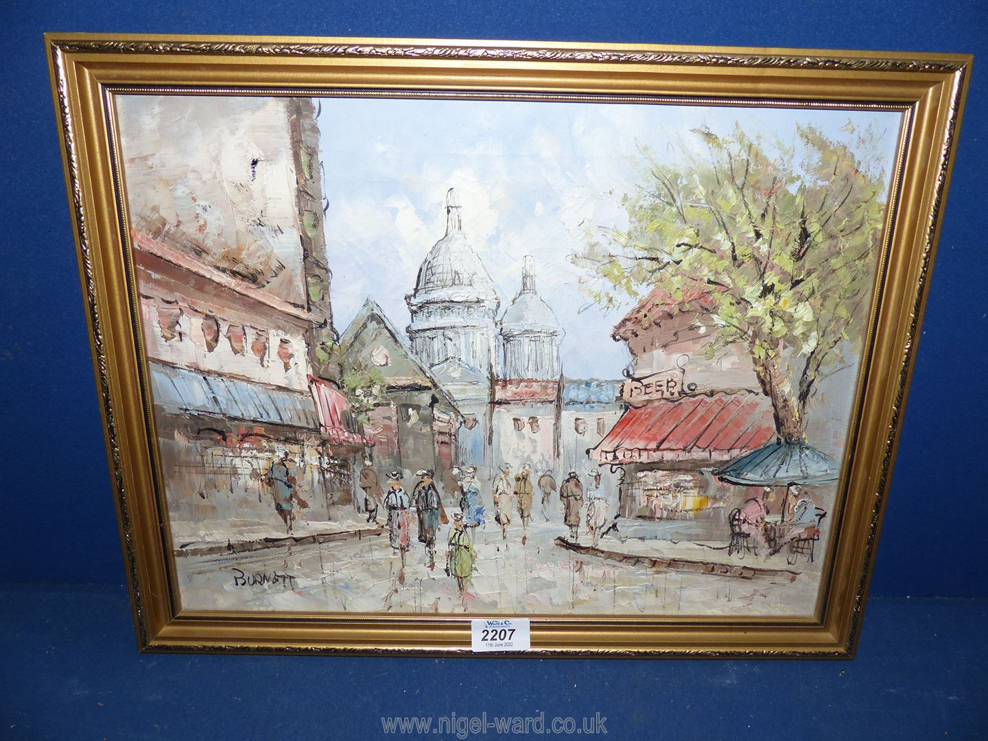 A framed oil on canvas depicting a street scene, signed lower left 'Burnett'. - Image 2 of 2