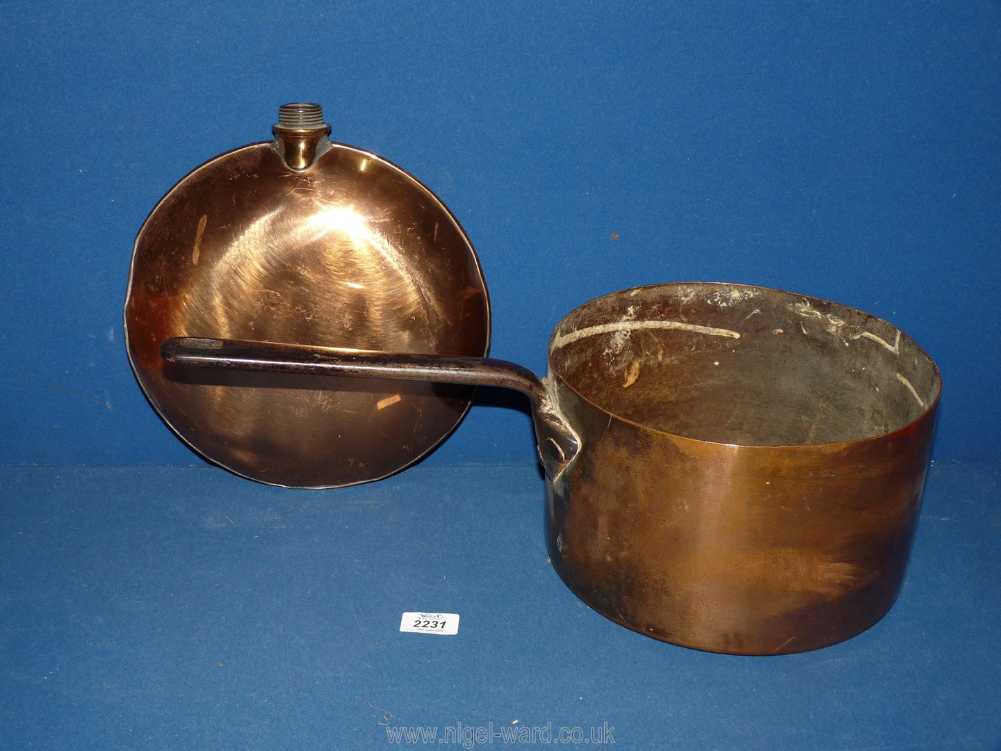 A copper hot water warming container, no stopper and heavy copper saucepan.