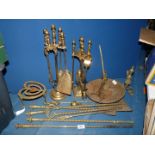 A quantity of mixed brass including fire irons, trivets, etc.