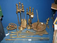 A quantity of mixed brass including fire irons, trivets, etc.