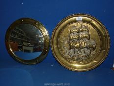 A brass convex porthole mirror, 15'' diameter and a brass wall plaque of a galleon,