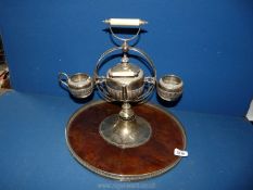 A plated teapot and milk jug on revolving Tray.