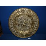 A large brass charger depicting tavern scene, 22 1/2" diameter.