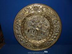 A large brass charger depicting tavern scene, 22 1/2" diameter.