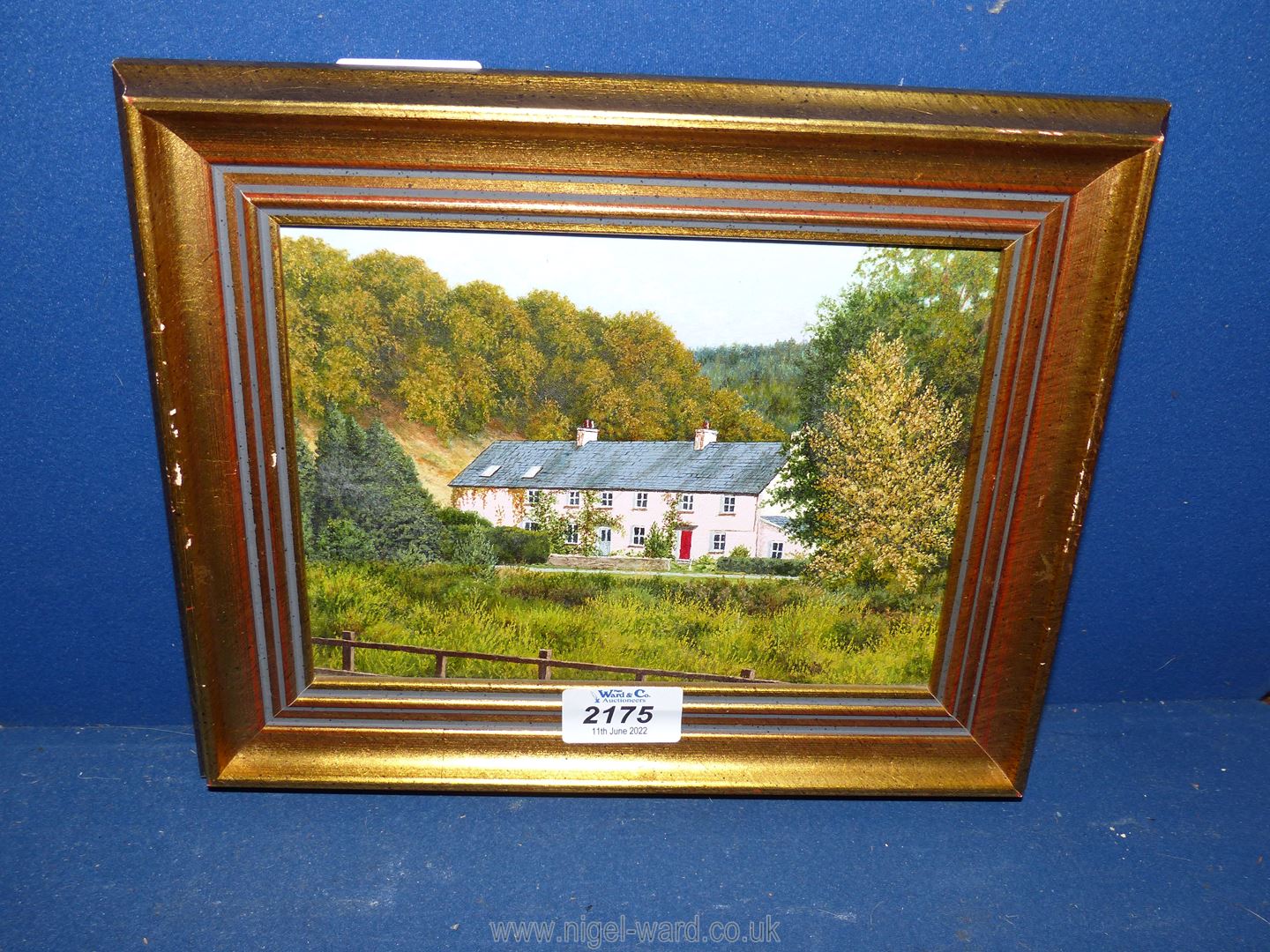 A small framed Oil on board titled verso 'Cottages Nr. Tintern', 11" x 8 3/4".