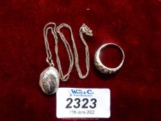 A vintage silver ring set 18 clear stones, stamped 925, plus an oval locket and chain, stamped 925.