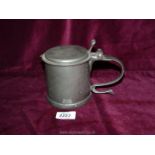 A vintage Commonwealth style Pewter Tankard with scroll handle and Charles medallion under the lid.