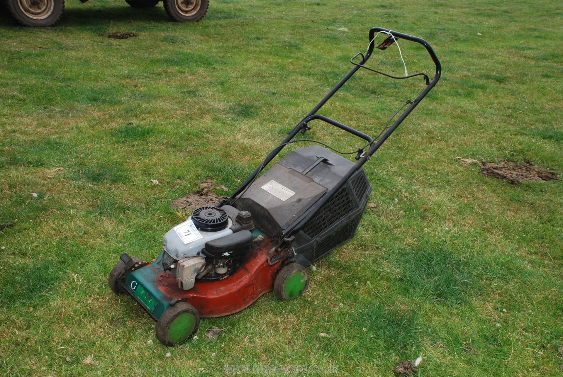 A Gardenline petrol engined rotary mower with grass collector box.