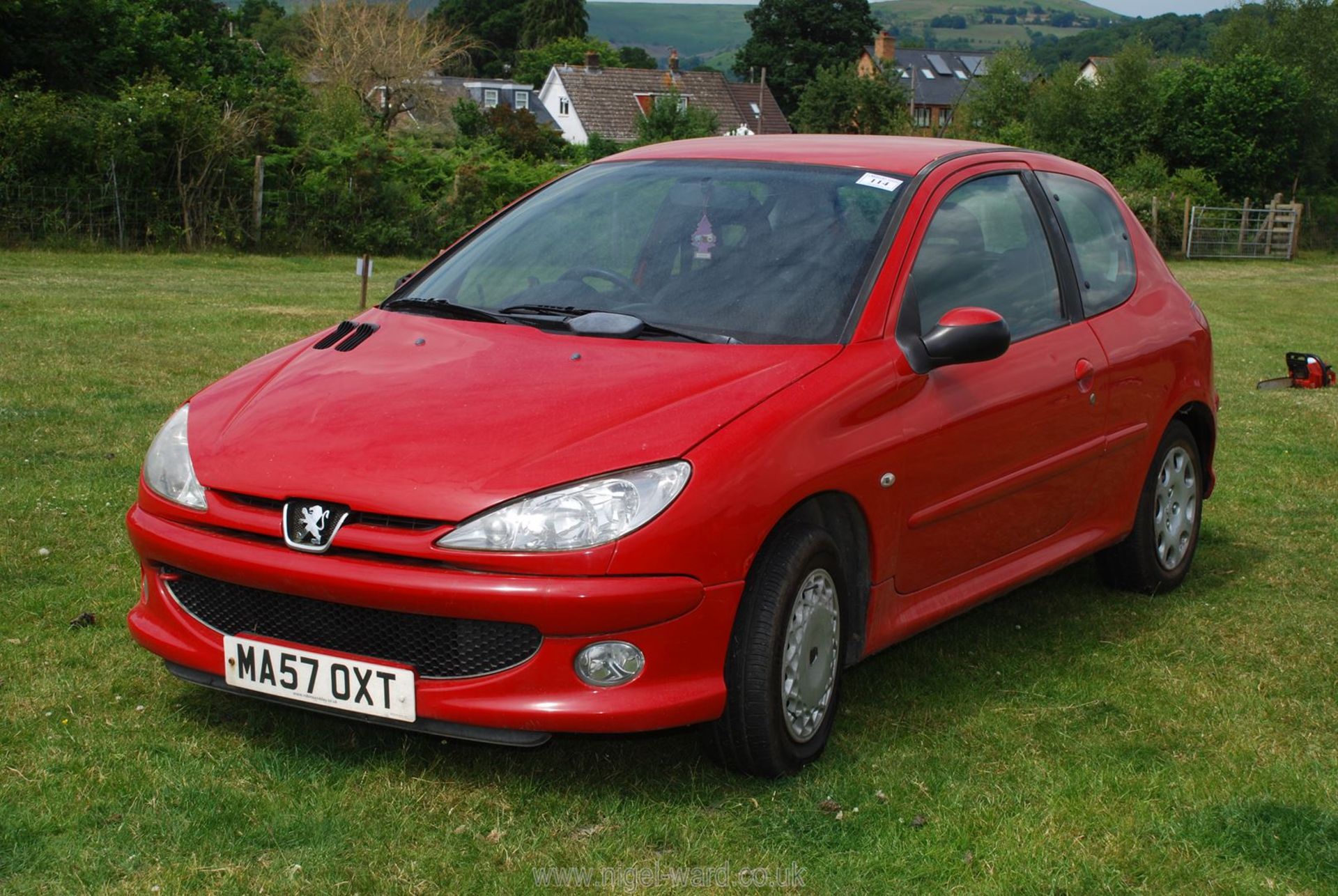 A petrol engined Peugeot 206 hatchback 1.4 Look 3 door in red