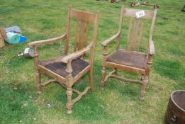 A pair of elbow chairs.