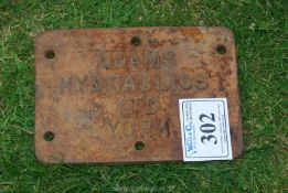 A cast iron name plate 'Adams York'.