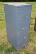 A four drawer metal filing cabinet.