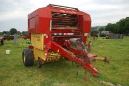A New Holland 835 big round Baler, (control box and books in office).