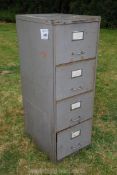 A four drawer steel filing cabinet.