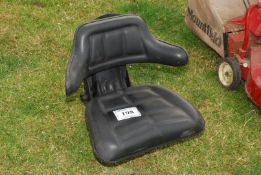 A sprung wrap around tractor seat.