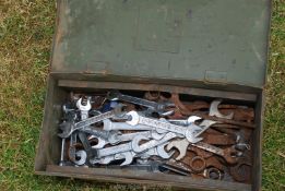 An ammunition box with various size spanners.