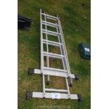 Two galvanised ladders; one being extendable.