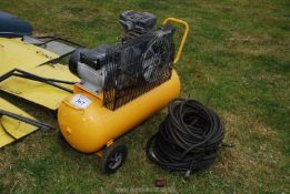 A portable compressor with air tank and air hose.