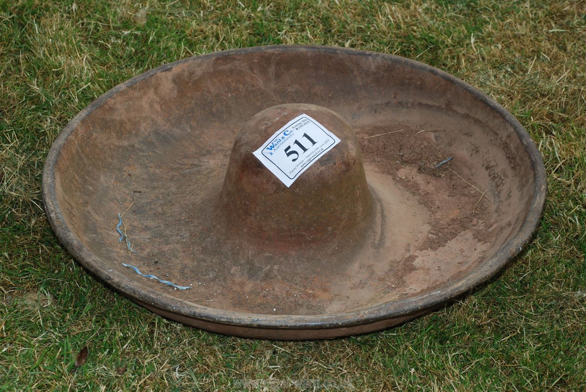 A cast iron pig round feeder, 29'' diameter.