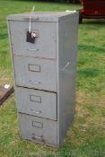 A four drawer steel filing cabinet.