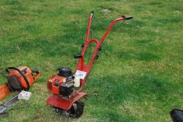 A compact rotary garden cultivator, (with compression but no fuel present).