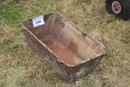 A cast iron feed trough, 25 1/2'' x 14 1/2'' x 8 1/2''.