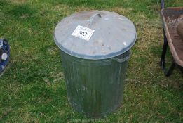 A galvanised dustbin.