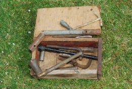 A wooden box containing box spanners.