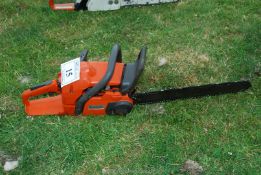 A Husqvarna chainsaw with chain-brake, good compression. Ran at time of lotting.