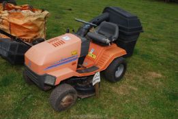 A Husqvarna LT-130 Briggs & Stratton 13HP petrol engined ride on mower with grass collection box.