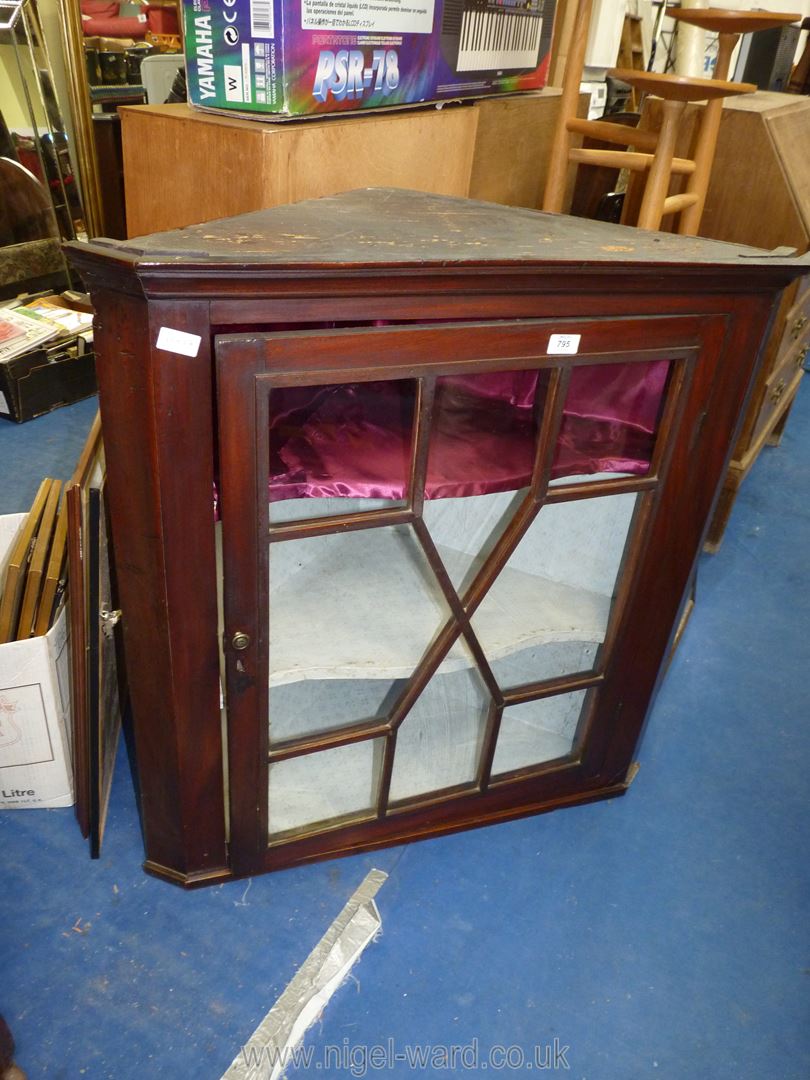 Wall hanging corner cupboard, dark wood with glazed door.