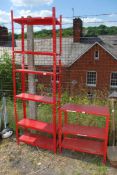 Red adjustable metal workshop shelving.