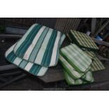 A quantity of garden seat cushions in gingham check.