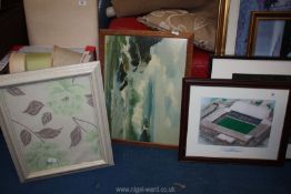 Three prints of a football stadium, floral and seascape.