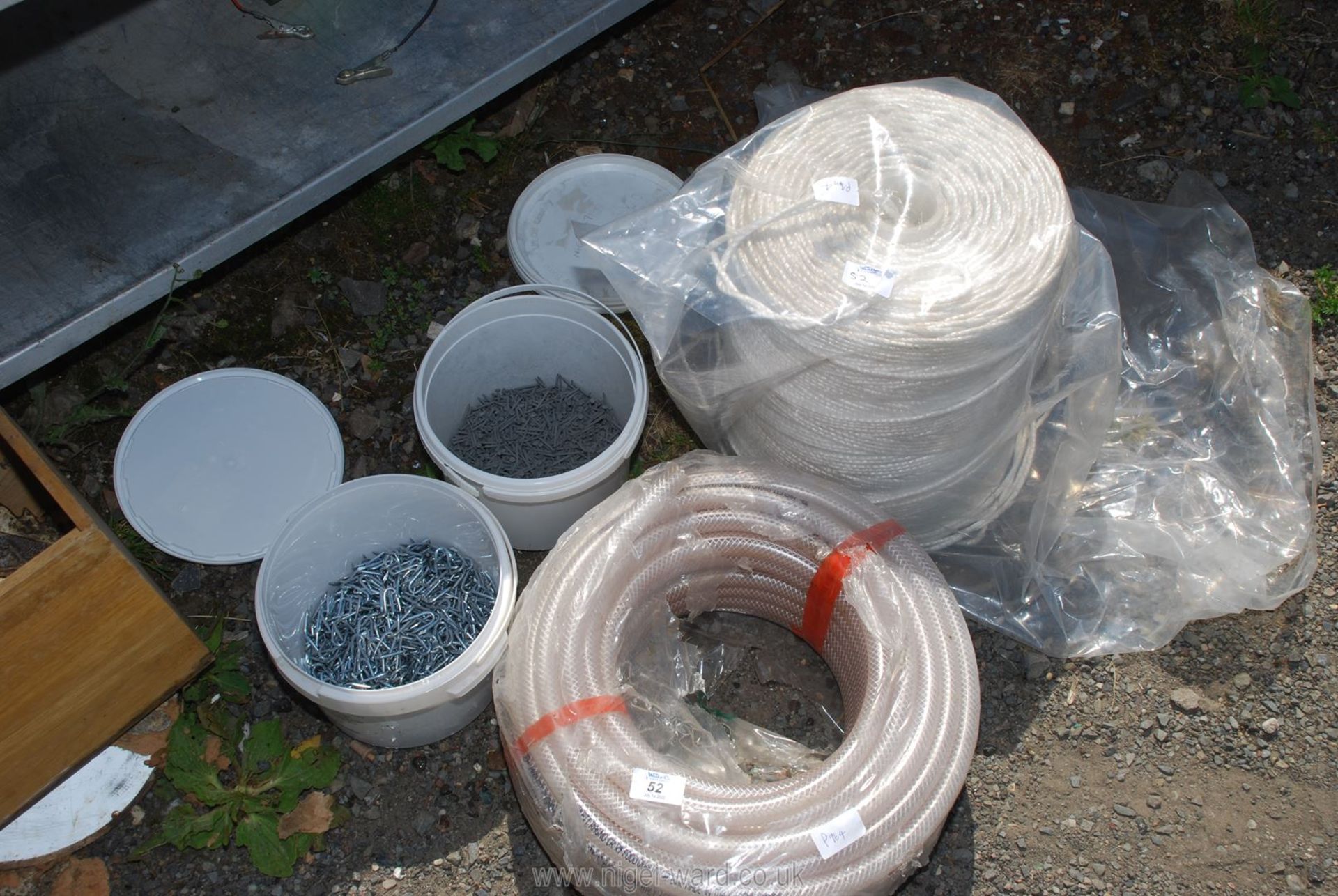 Roll of 15 ml reinforced plastic tubing, tubs of nails,