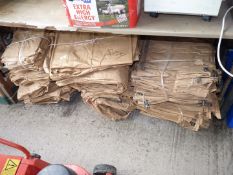 A large quantity of used brown paper potato sacks.