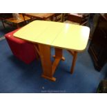 A yellow Formica drop leaf kitchen table.