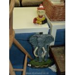 A cast metal elephant doorstop and novelty money box.