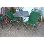 An Alexander Rose metal bistro set with green and cream cushions approx 23 1/2" square x 28" (h).