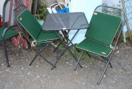 An Alexander Rose metal bistro set with green and cream cushions approx 23 1/2" square x 28" (h).