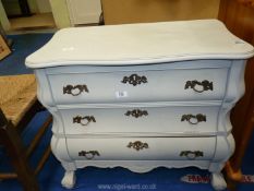 A grey painted bedroom chest with drop down front.