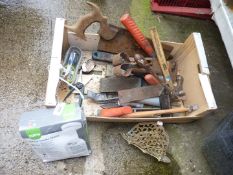 A box of old tools including shears, hammers, saw, etc.