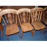 Three kitchen chairs with lyre style splats.