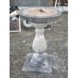 A large concrete bird bath on plinth approx. 17 1/2" x 28".