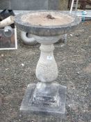 A large concrete bird bath on plinth approx. 17 1/2" x 28".