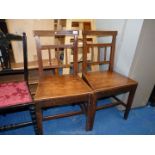 A pair of solid seated hall chairs.