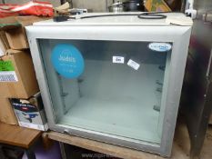 An Interlevin glass doored small freezer.